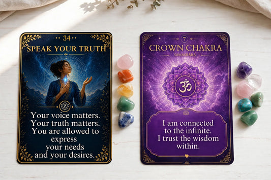 Chakra oracle cards in a neat row with rainbow stones on a bright white table